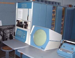 An original PDP-1 computer - a circular monitor next to a large input console