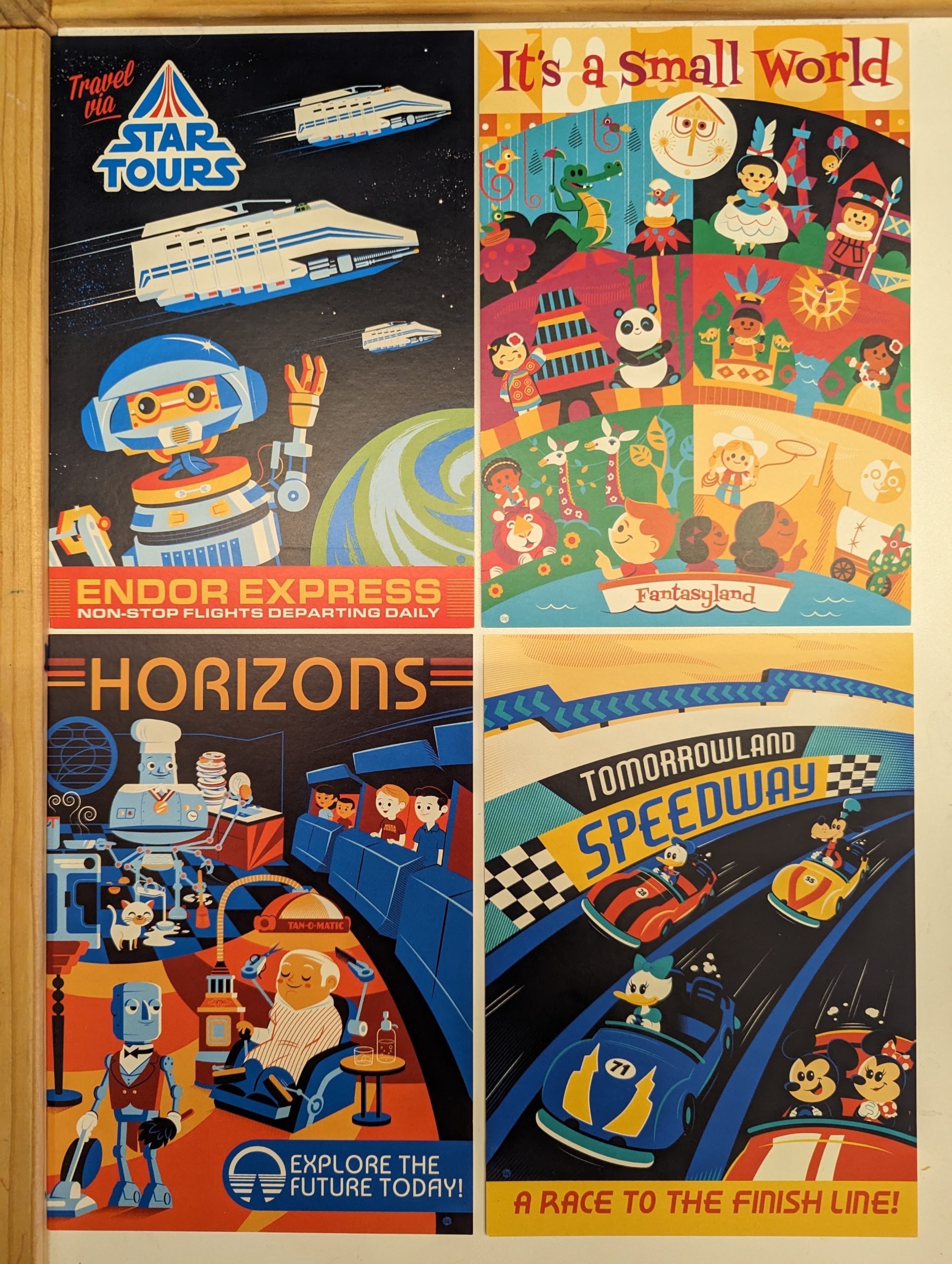 Four postcards by Dave Perillo: Star Tours, It's a Small World, Horizons, Tomorrowland Speedway